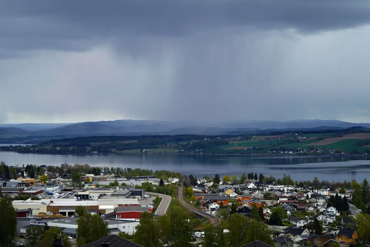 Roof Leak Repair in Monroe Township — rain falling over a lakeside town